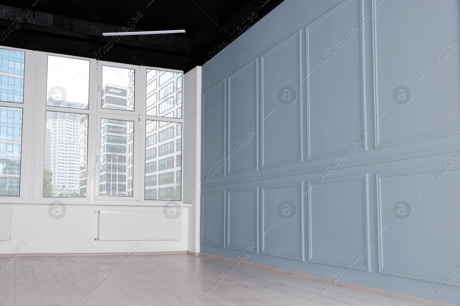 Photo of Empty office room with black ceiling and windows. Interior design