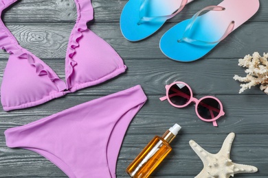 Photo of Flat lay composition with beach objects on wooden background