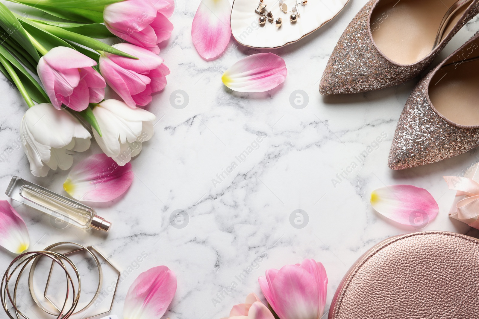 Photo of Flat lay composition of beautiful tulips and accessories on marble background, space for text. International Women's Day