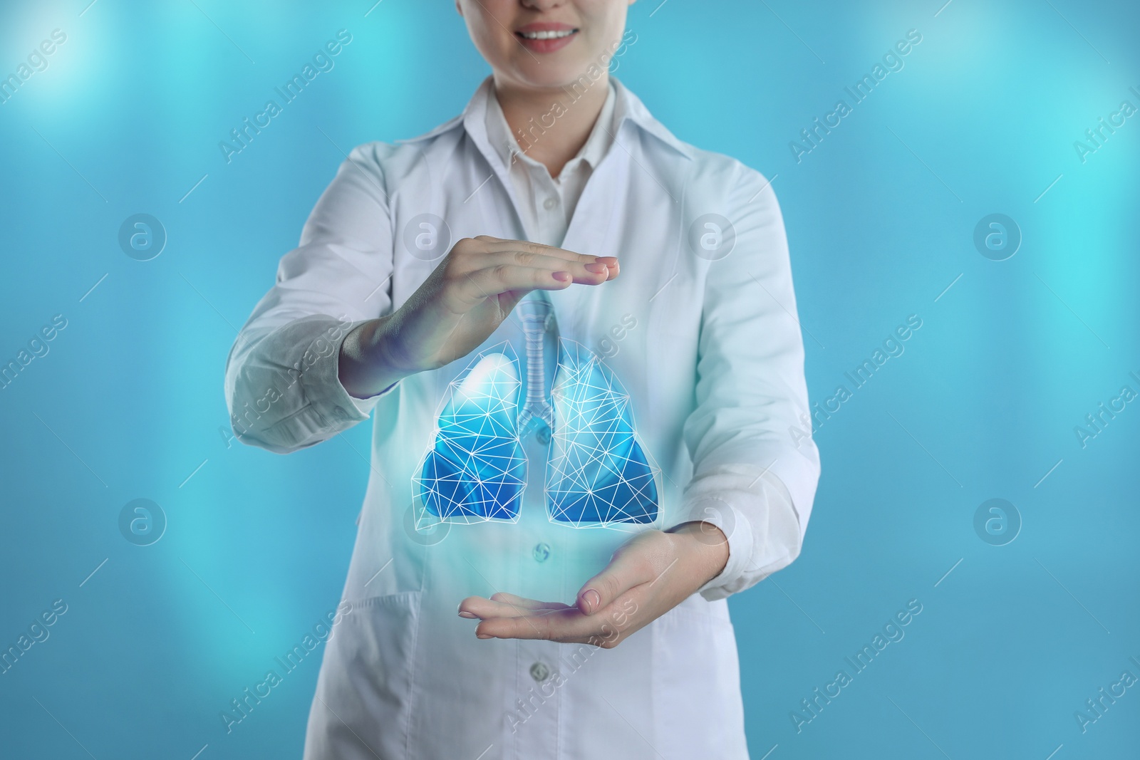 Image of Doctor demonstrating digital image of human lungs on blue background, closeup