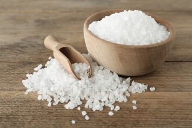 Natural sea salt, bowl and scoop on wooden table