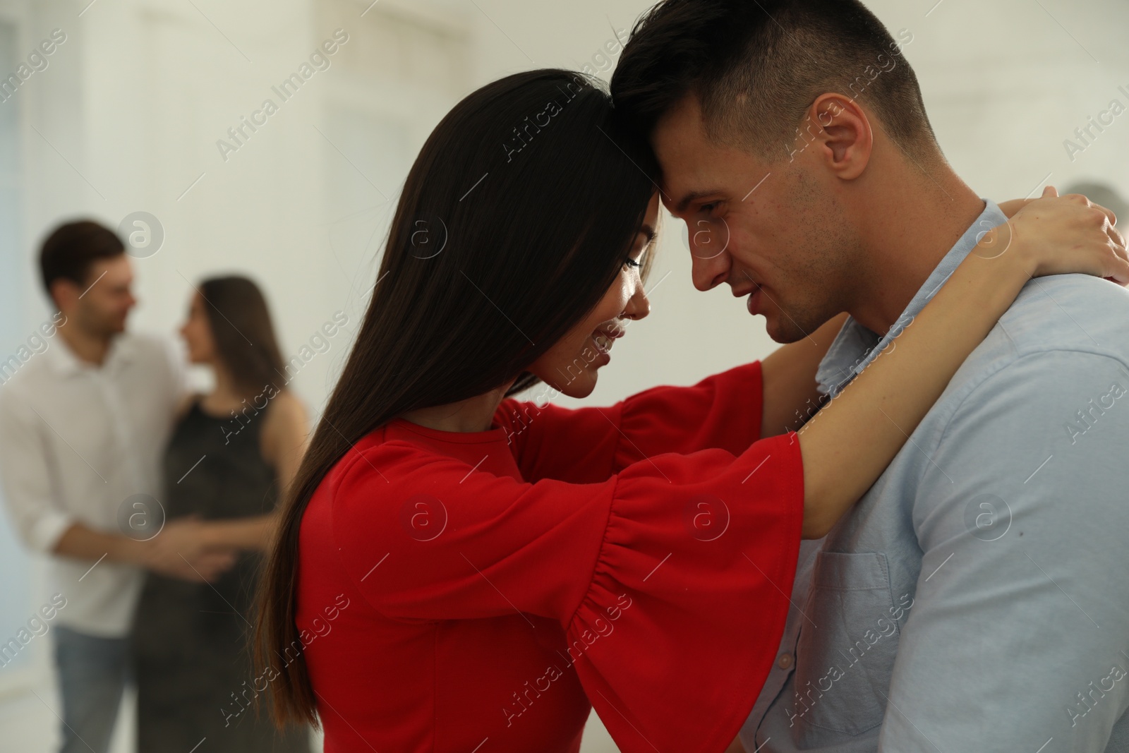 Photo of Lovely young couple dancing together at party