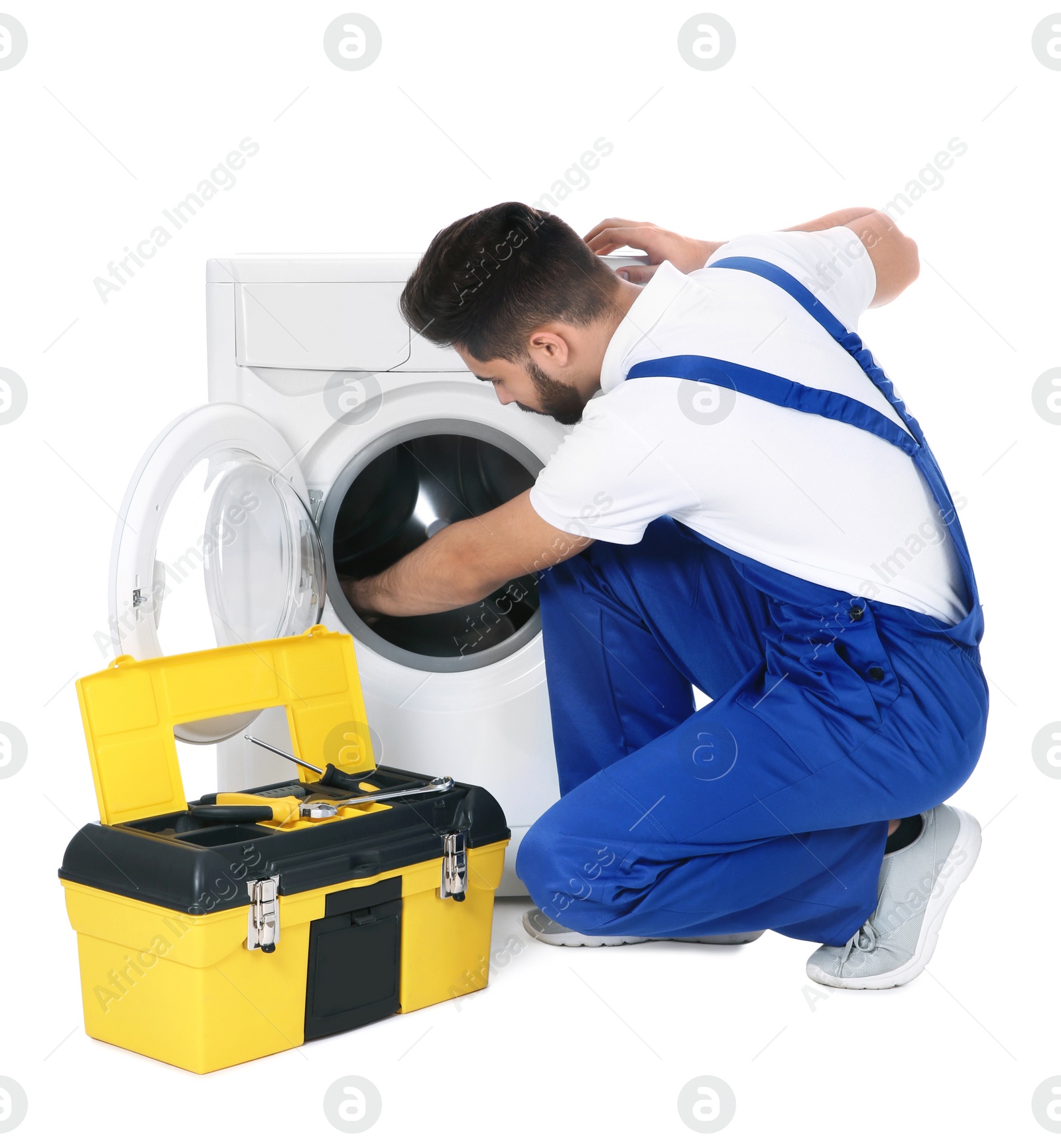 Photo of Plumber repairing washing machine on white background