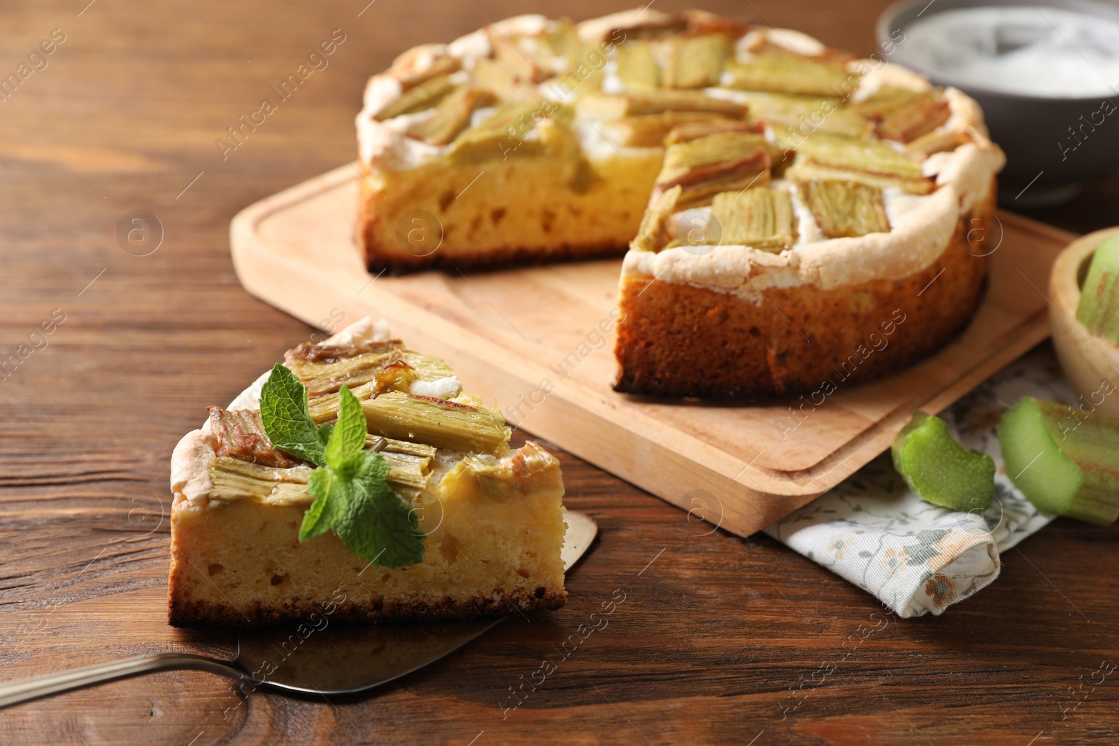 Photo of Freshly baked rhubarb pie and cake server on wooden table