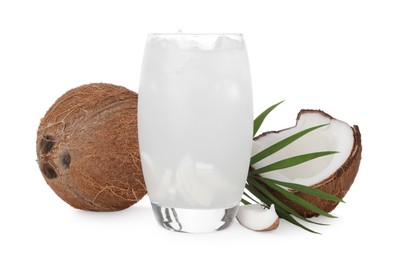 Photo of Glass of coconut water, ice cubes, leaf and nuts isolated on white