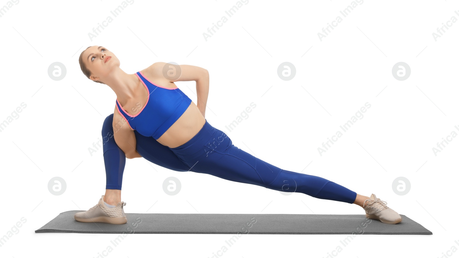 Photo of Yoga workout. Young woman stretching on white background