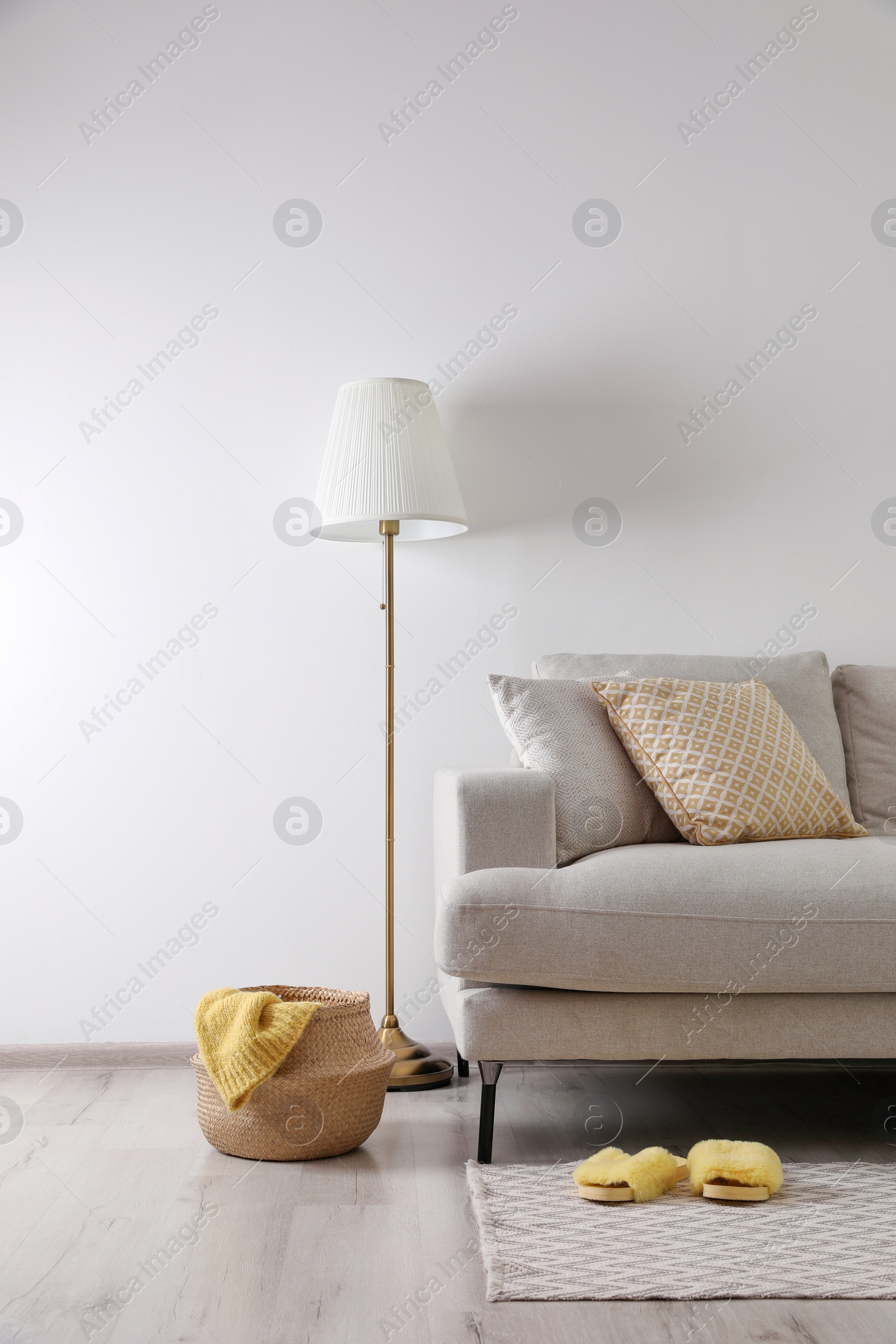 Photo of Interior of living room with comfortable sofa and floor lamp