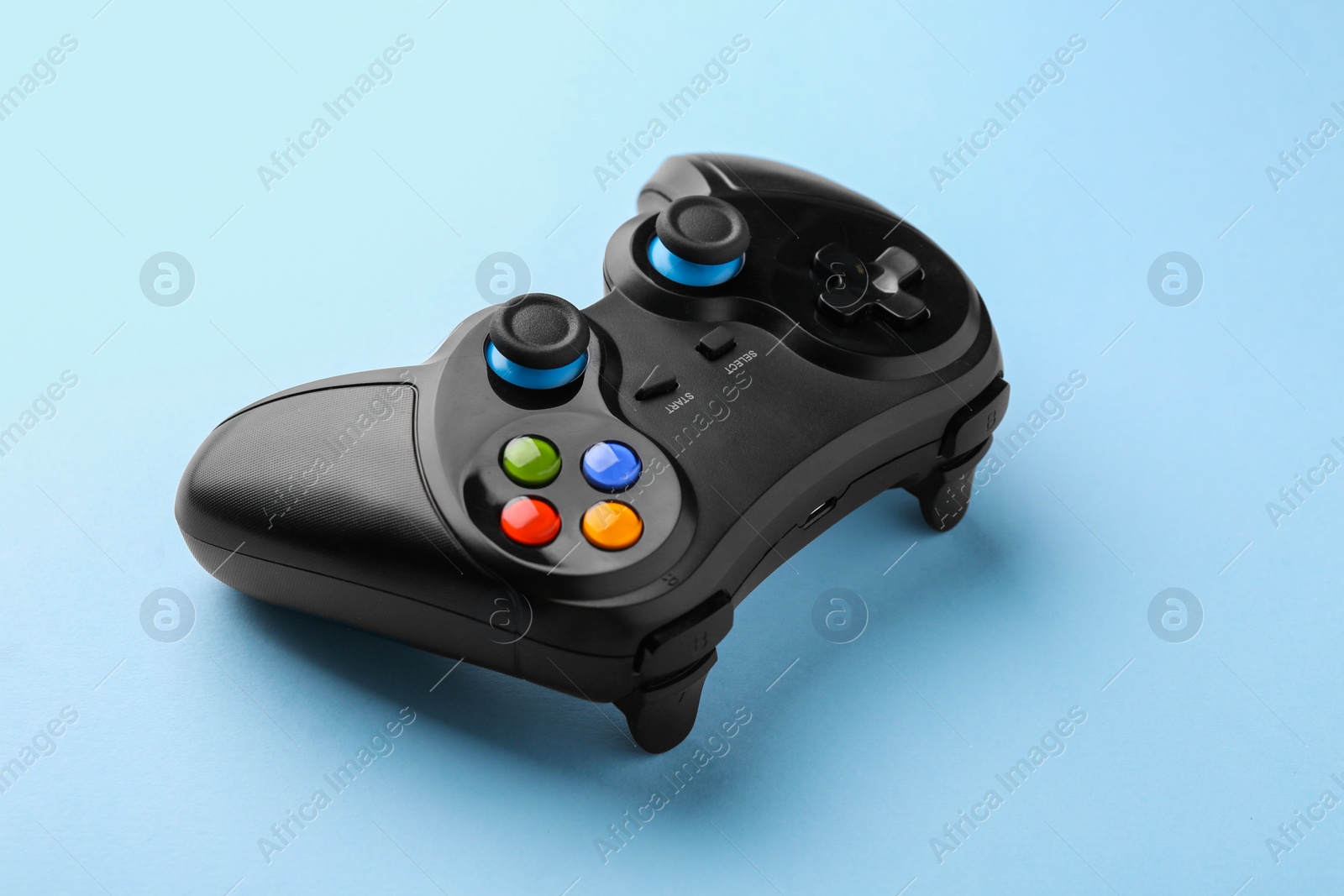 Photo of Wireless game controller on light blue background