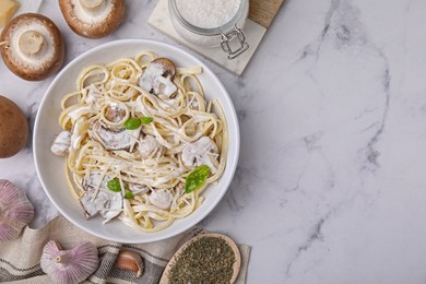 Photo of Delicious pasta with mushrooms served on white marble table, flat lay. Space for text