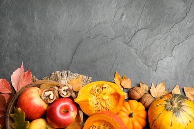 Photo of Flat lay composition with vegetables, fruits and autumn leaves on black slate table, space for text. Thanksgiving Day