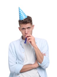 Photo of Young man in party hat with blower on white background