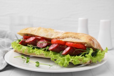 Photo of Delicious sandwich with sausages and vegetables on white table, closeup. Space for text