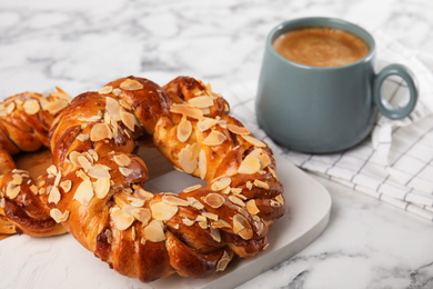 Delicious pastries and coffee on marble table, closeup