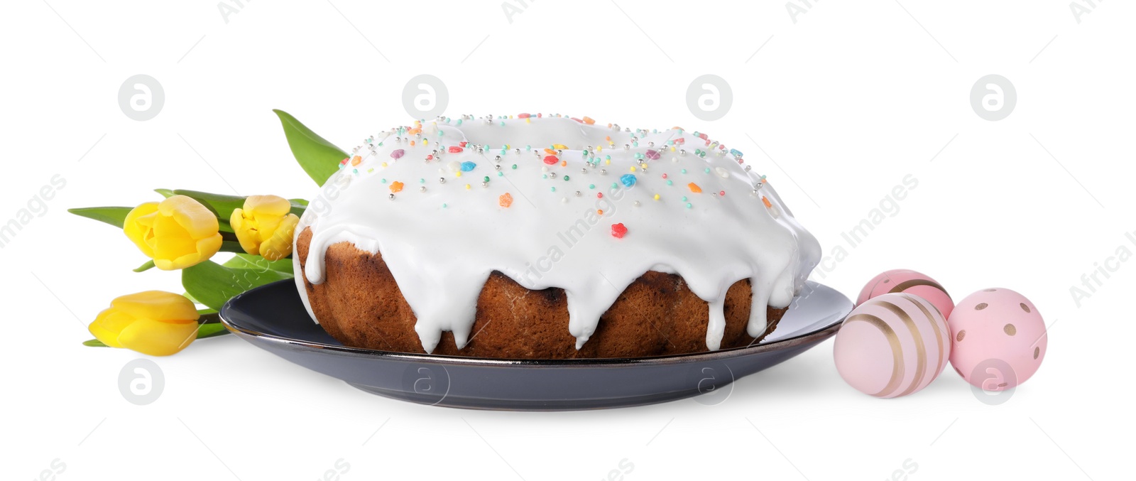 Photo of Easter cake with sprinkles, yellow tulips and decorated eggs isolated on white