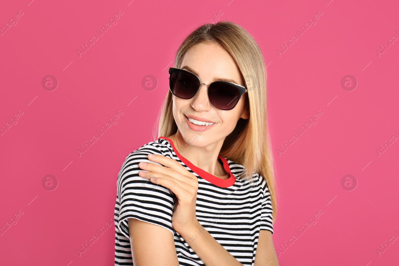 Photo of Beautiful woman in stylish sunglasses on pink background