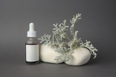 Photo of Cosmetic product, stones and silver leaves on dark grey background