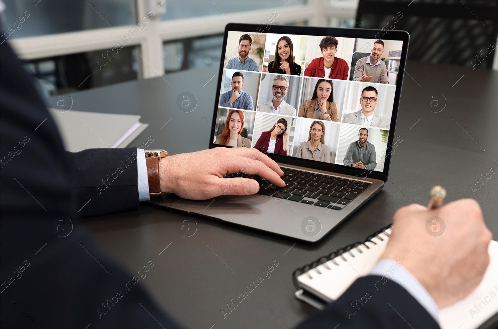 Image of Man participating in webinar via laptop at table, closeup