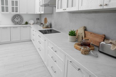 Photo of Beautiful kitchen interior with modern cooktop and stylish furniture