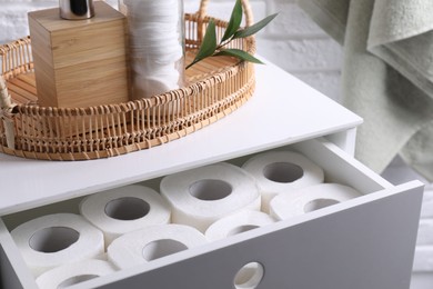 Photo of Many toilet paper rolls in white drawer indoors