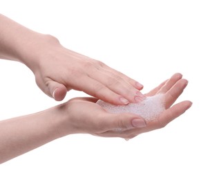 Woman with cleansing foam on hands against white background, closeup