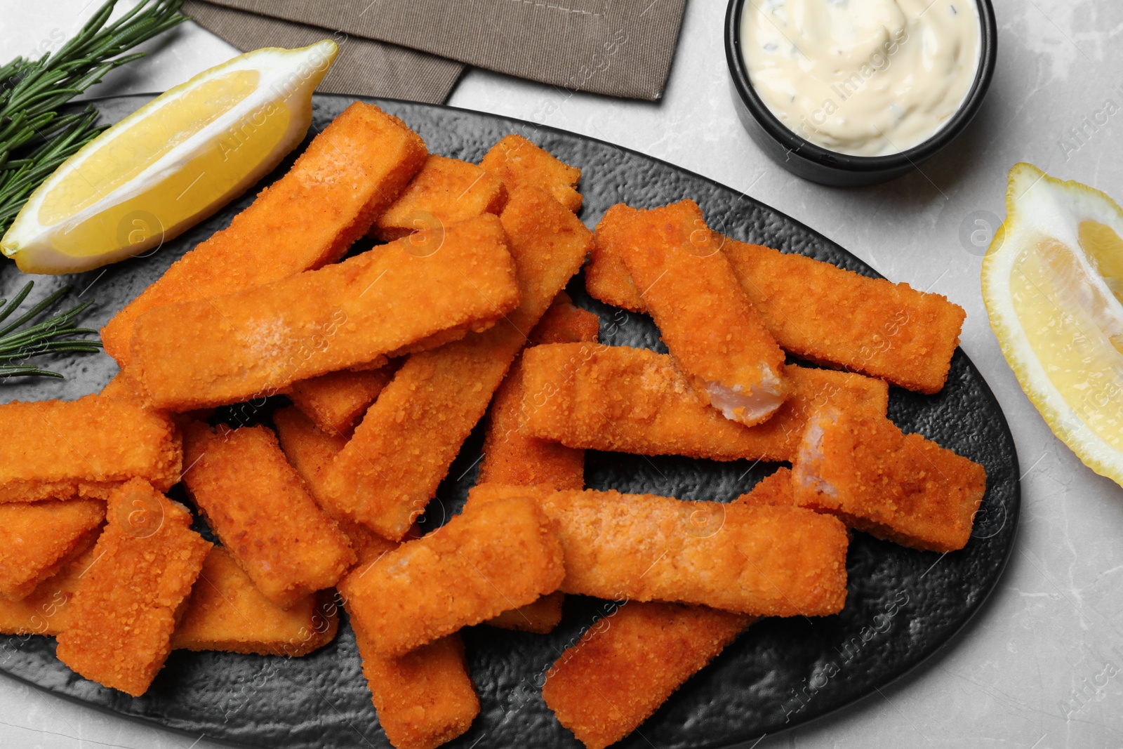 Photo of Tasty fresh fish fingers served on white table, flat lay