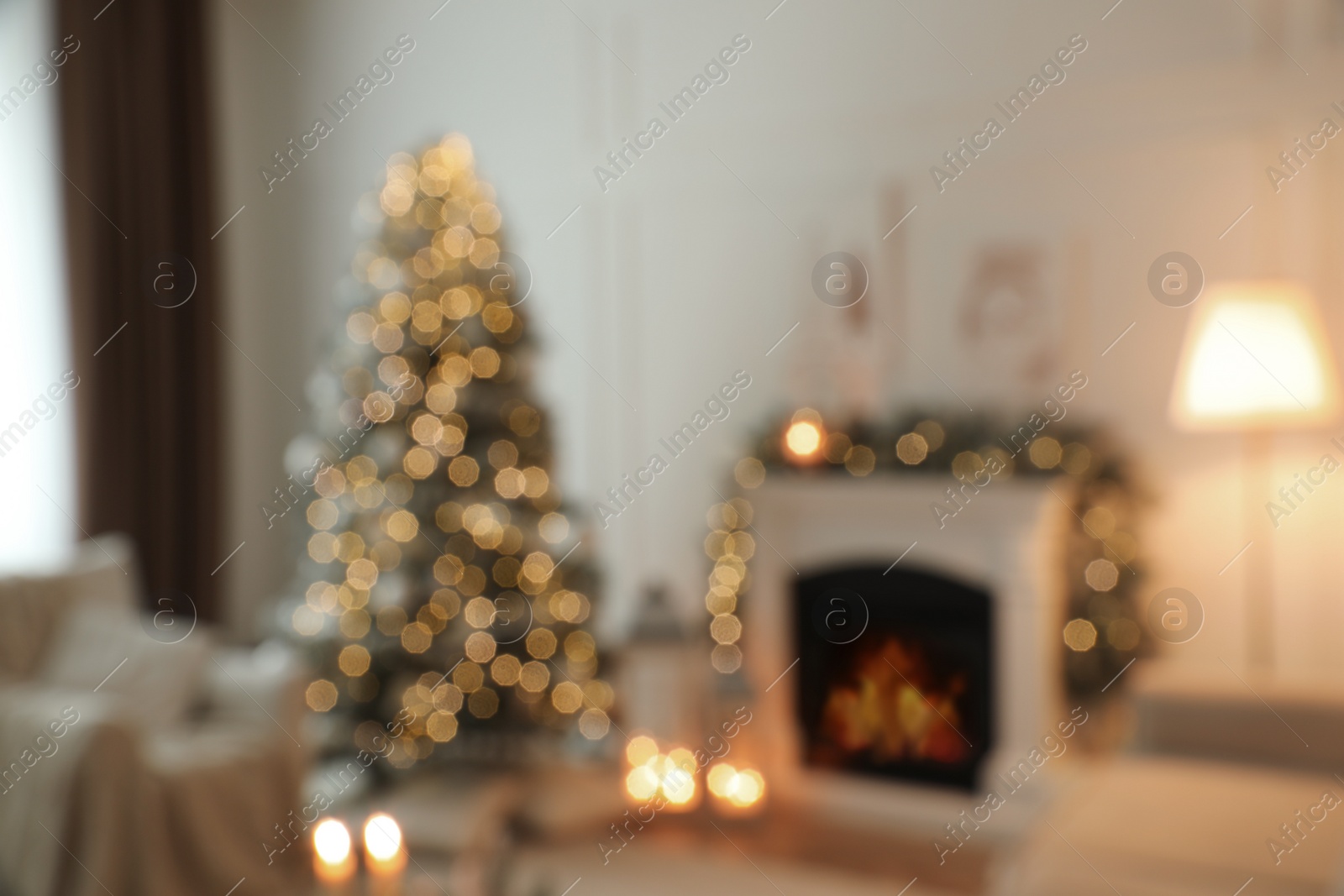 Photo of Blurred view of fireplace in living room decorated for Christmas