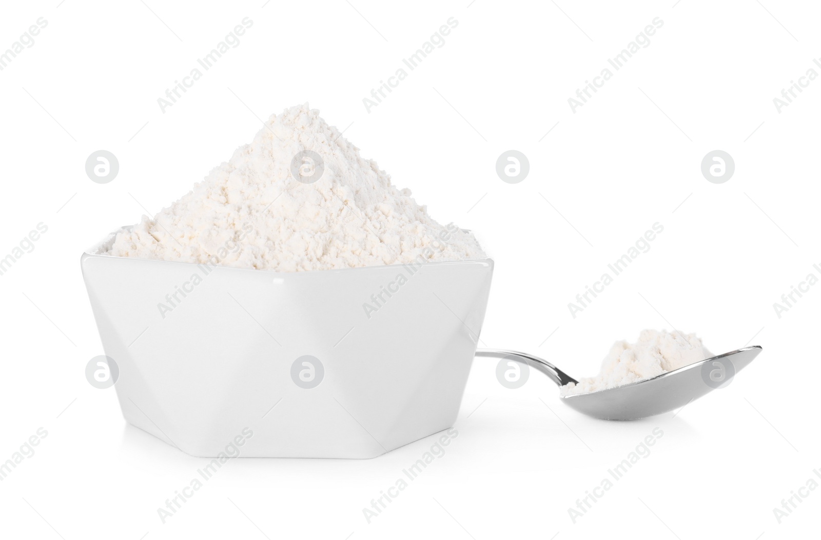 Photo of Bowl and spoon with flour on white background
