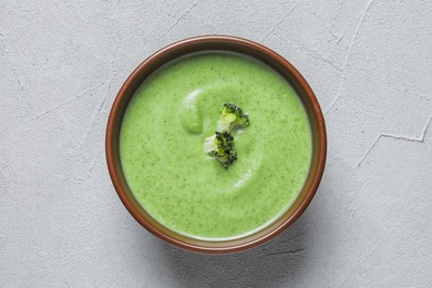 Photo of Fresh vegetable detox soup made of broccoli in dish on table, top view