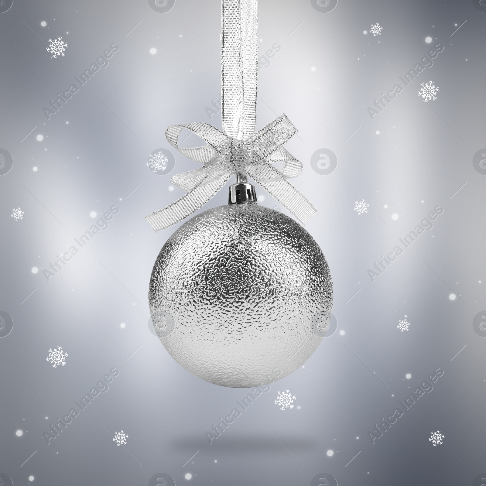 Image of Beautiful silver Christmas ball with bow and snowflakes on light grey background