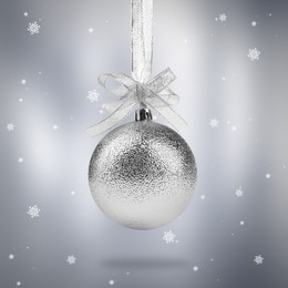 Image of Beautiful silver Christmas ball with bow and snowflakes on light grey background