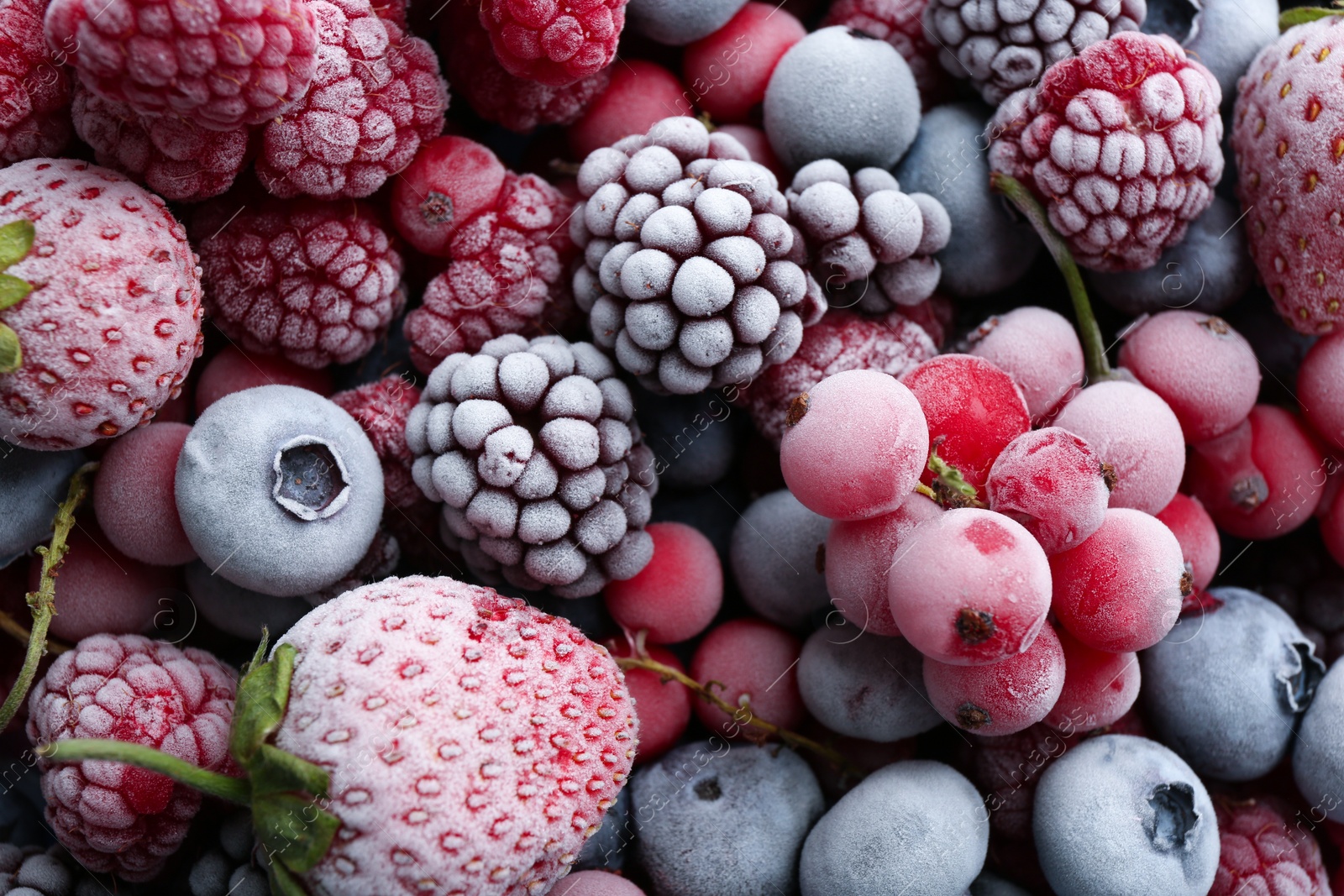 Photo of Mix of different frozen berries as background, top view