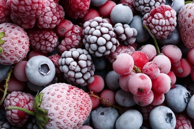 Mix of different frozen berries as background, top view