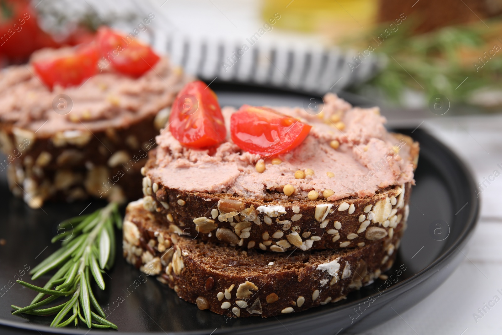 Photo of Delicious liverwurst sandwiches served on white table, closeup