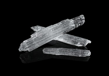 Photo of Menthol crystals on black background, closeup view