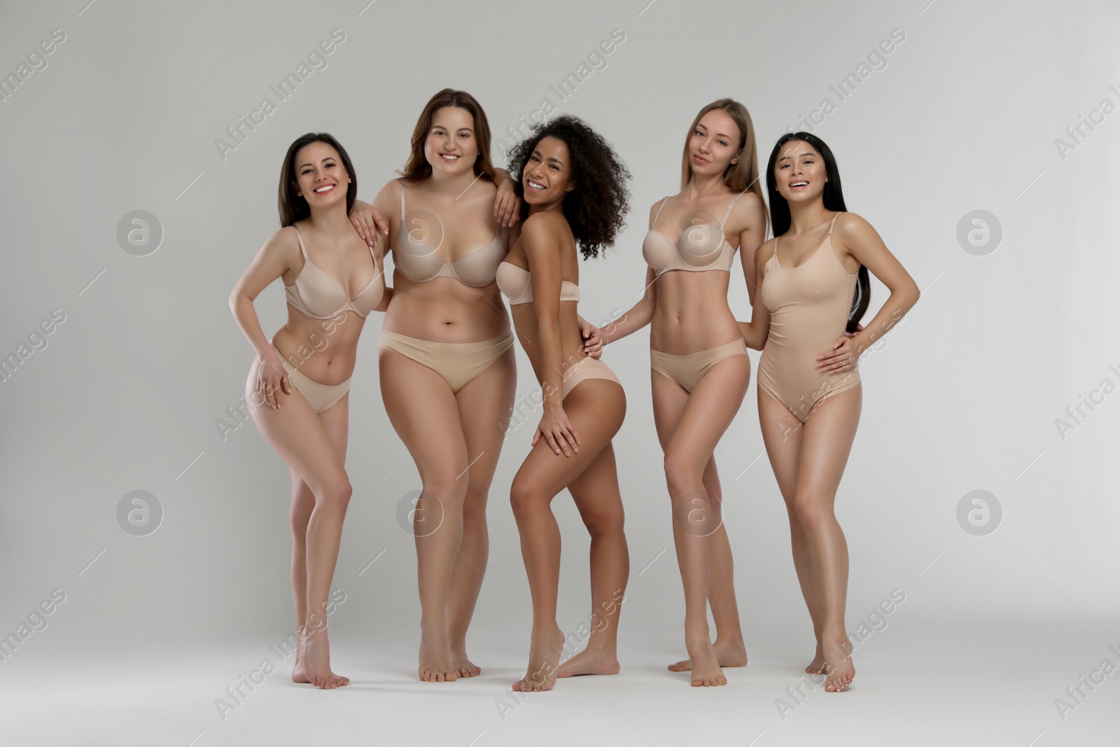 Photo of Group of women with different body types in underwear on light background