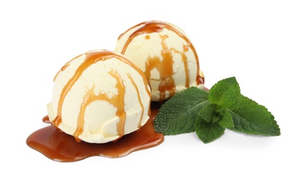 Photo of Delicious ice cream with mint and caramel sauce on white background