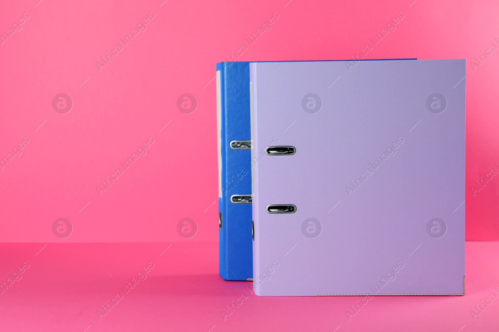 Photo of Office folders on pink background, space for text