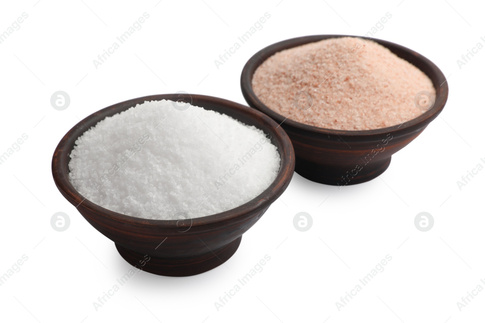 Photo of Different types of natural salt in bowls isolated on white