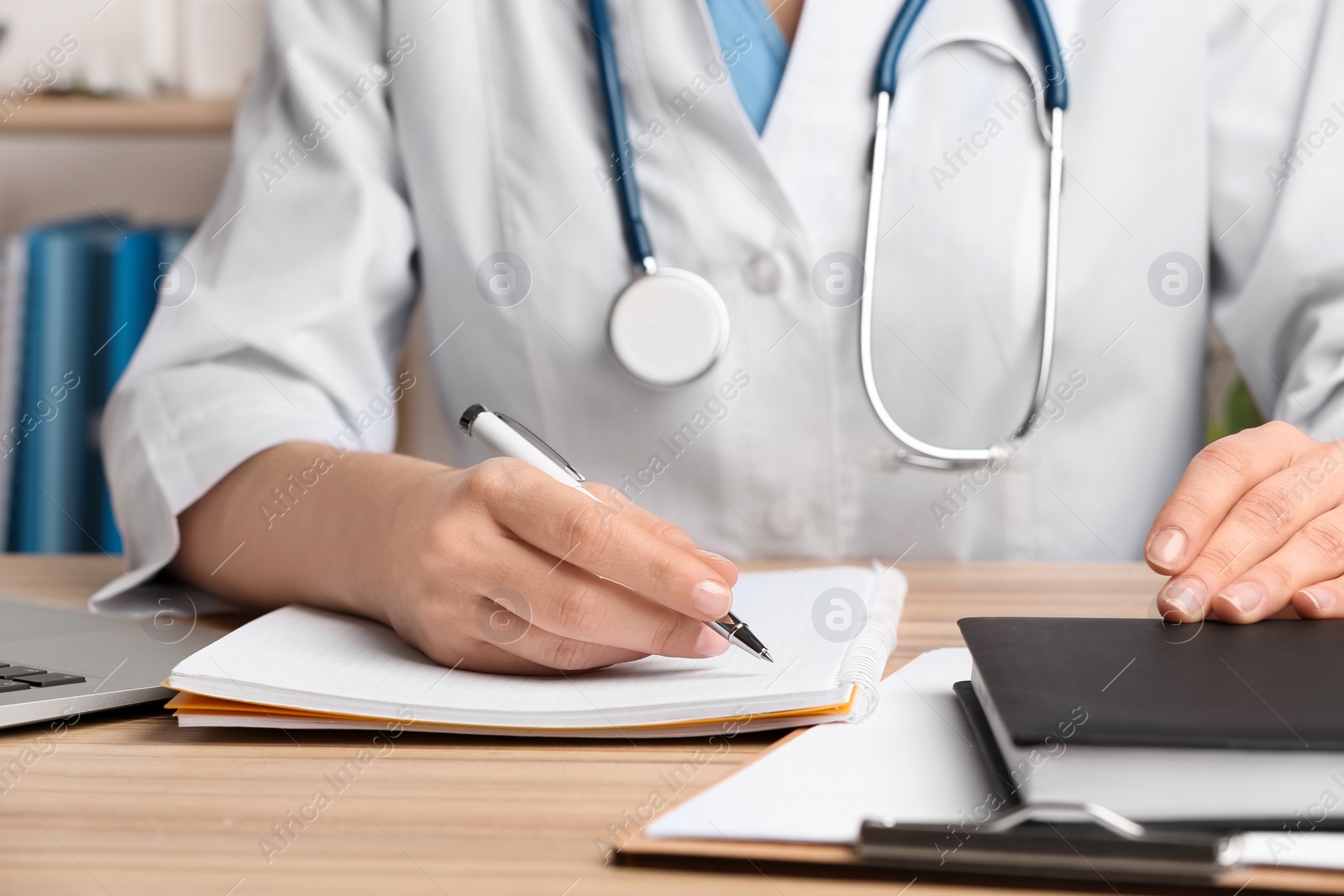 Photo of Doctor working at desk in office, closeup. Medical service