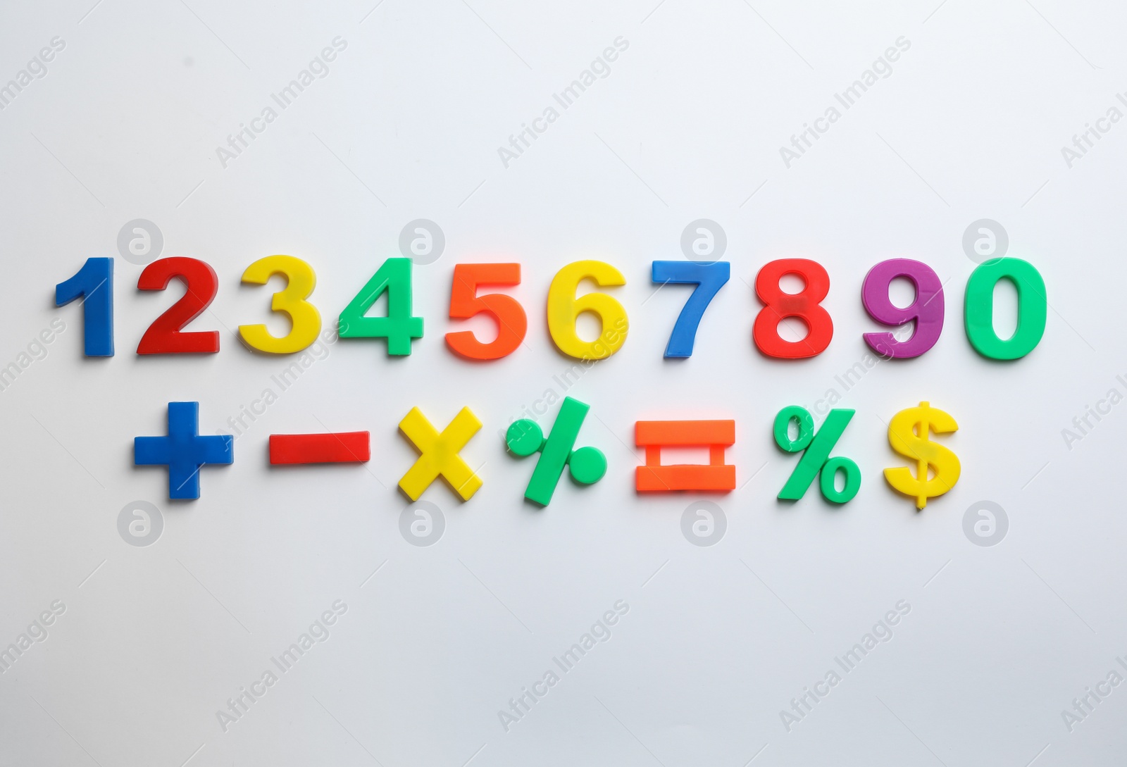Photo of Colorful magnetic numbers and math symbols on white background, top view