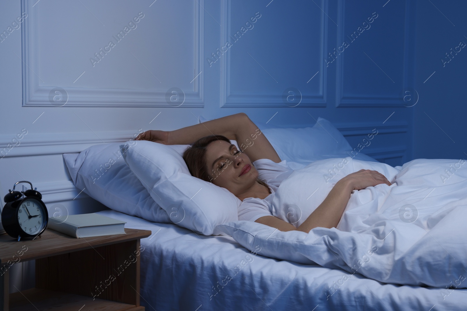 Photo of Beautiful woman sleeping in bed at night