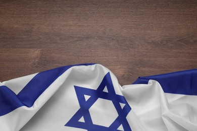 Flag of Israel on wooden background, top view and space for text. National symbol