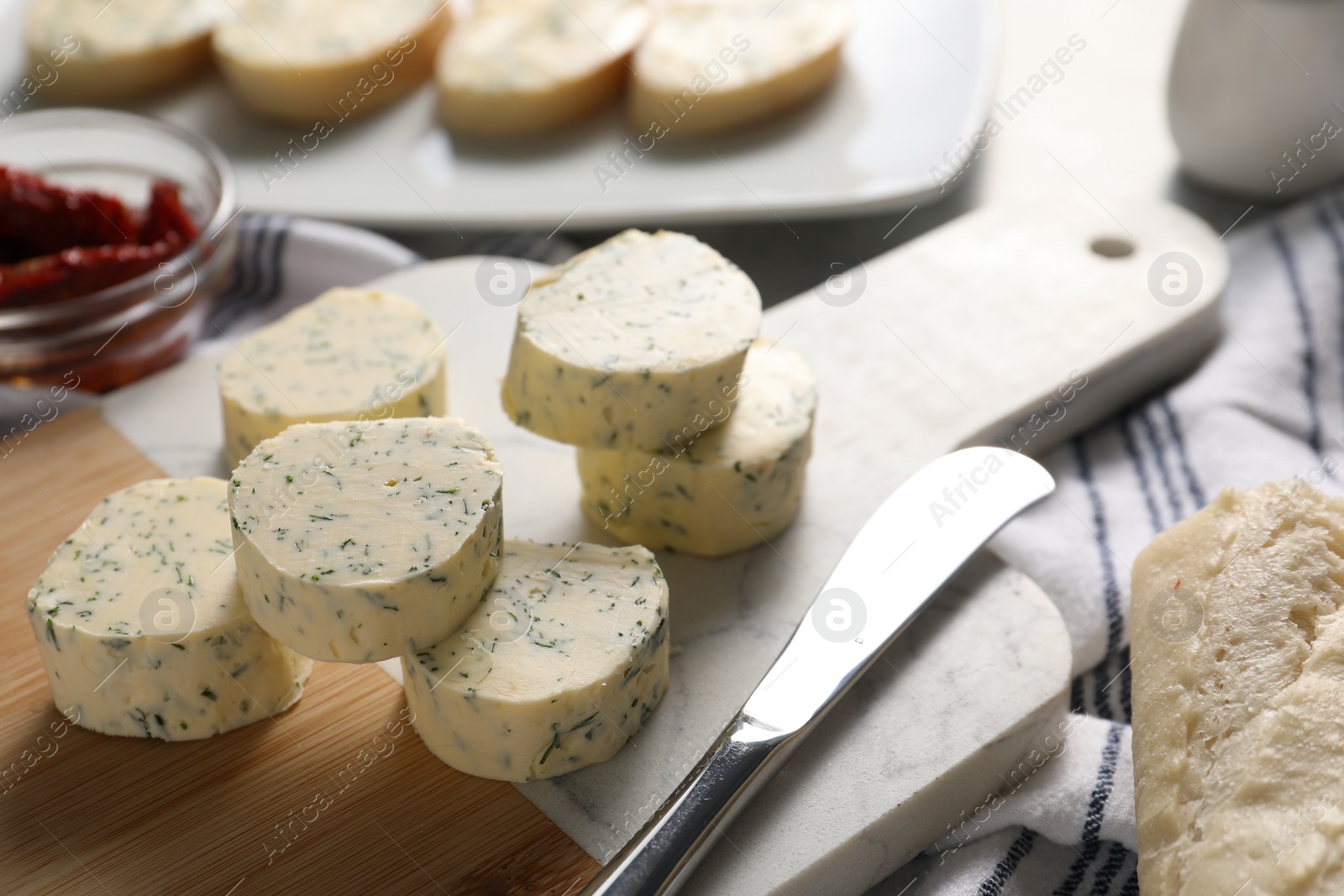 Photo of Tasty butter with dill and knife on table, closeup