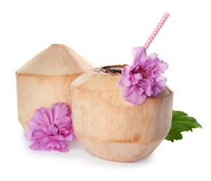Photo of Young peeled coconuts with straw, leaf and beautiful flowers on white background