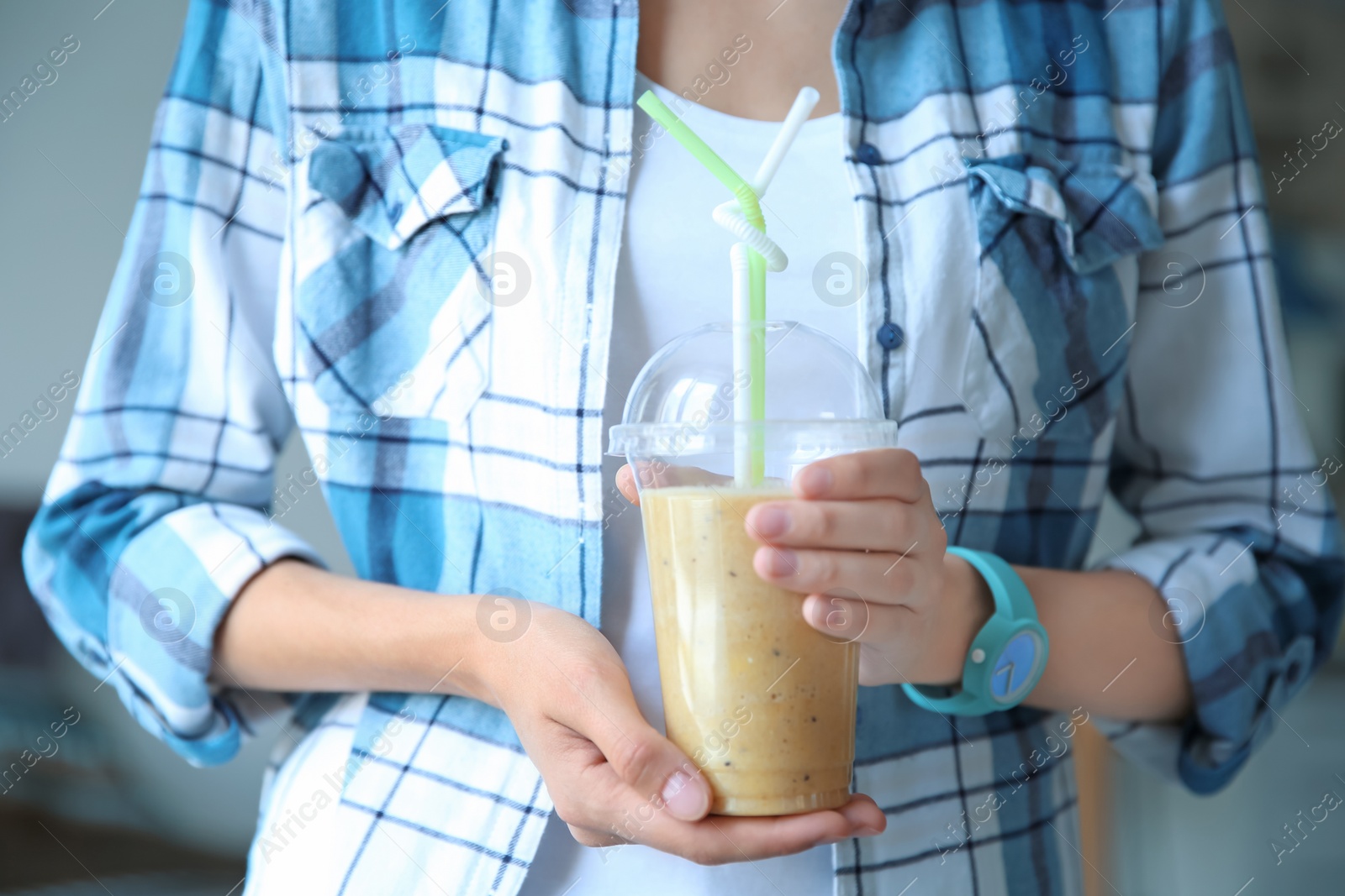 Photo of Young woman with plastic cup of healthy smoothie, closeup