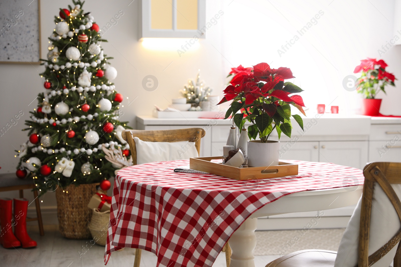 Photo of Beautiful kitchen interior with Christmas tree and festive decor