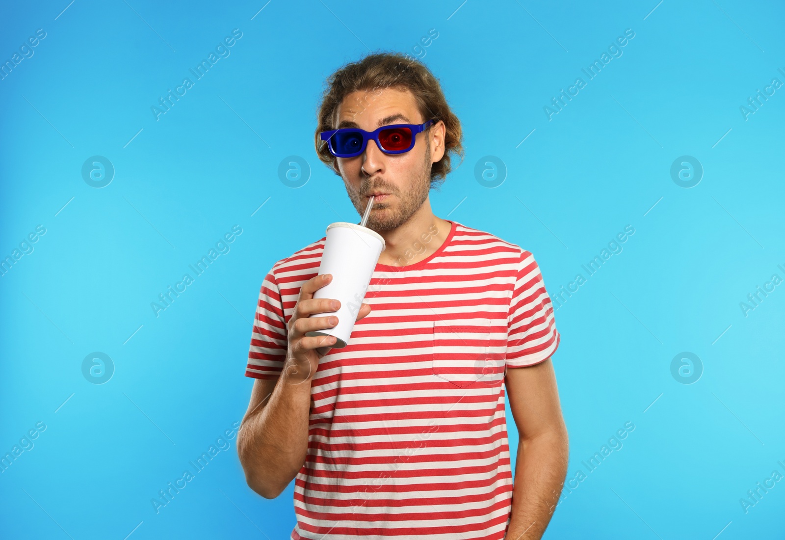 Photo of Emotional man with 3D glasses and beverage during cinema show on color background