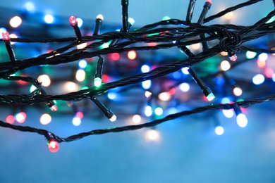 Beautiful Christmas lights on color background, closeup