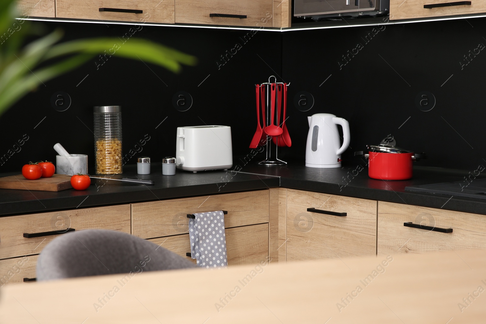 Photo of Kitchen interior with new furniture, appliances and houseware