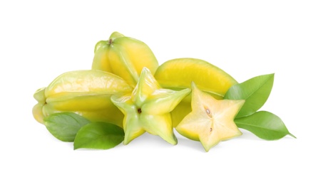 Photo of Cut and whole carambolas with green leaves on white background